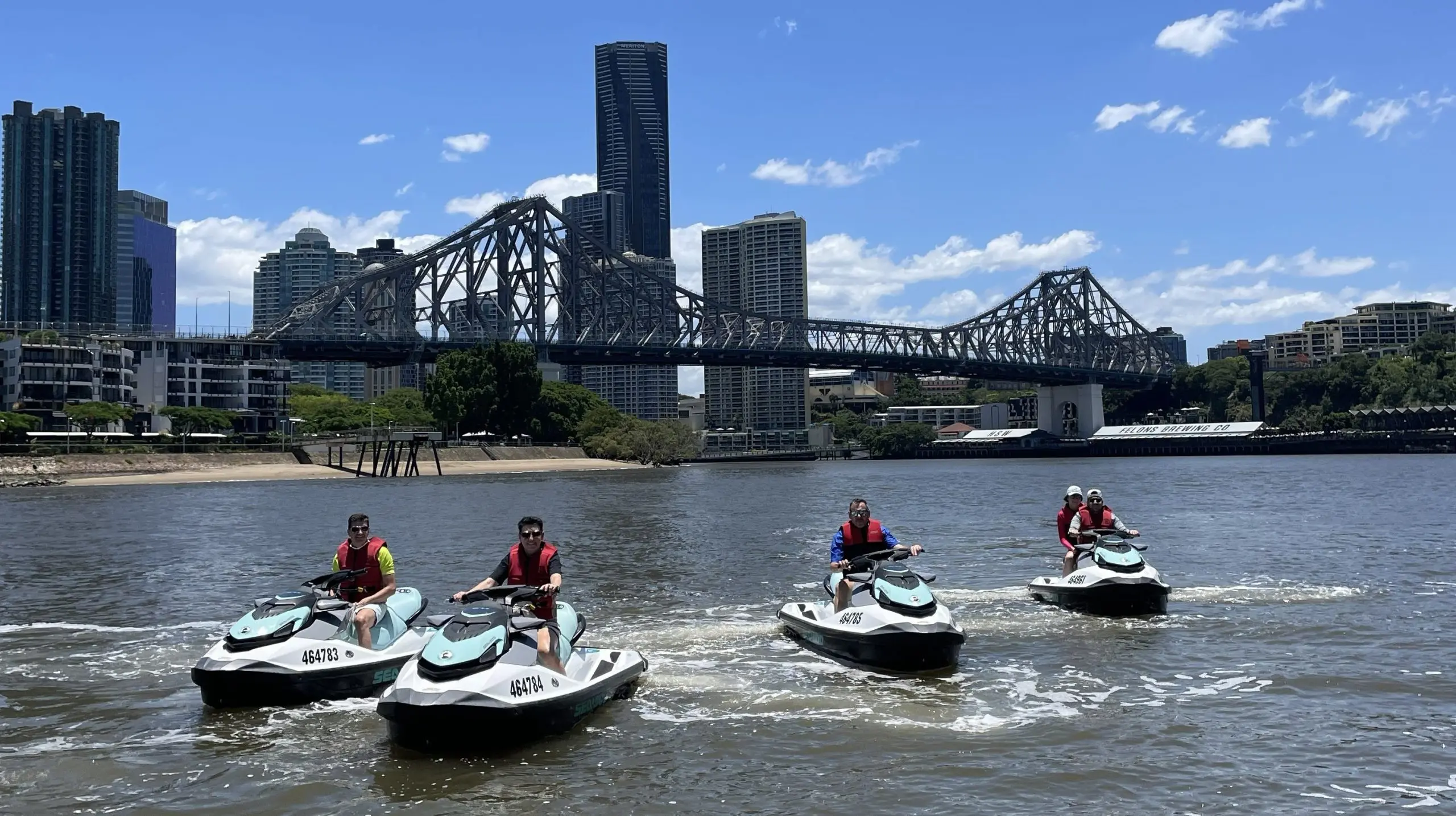 four jet skis story bridge